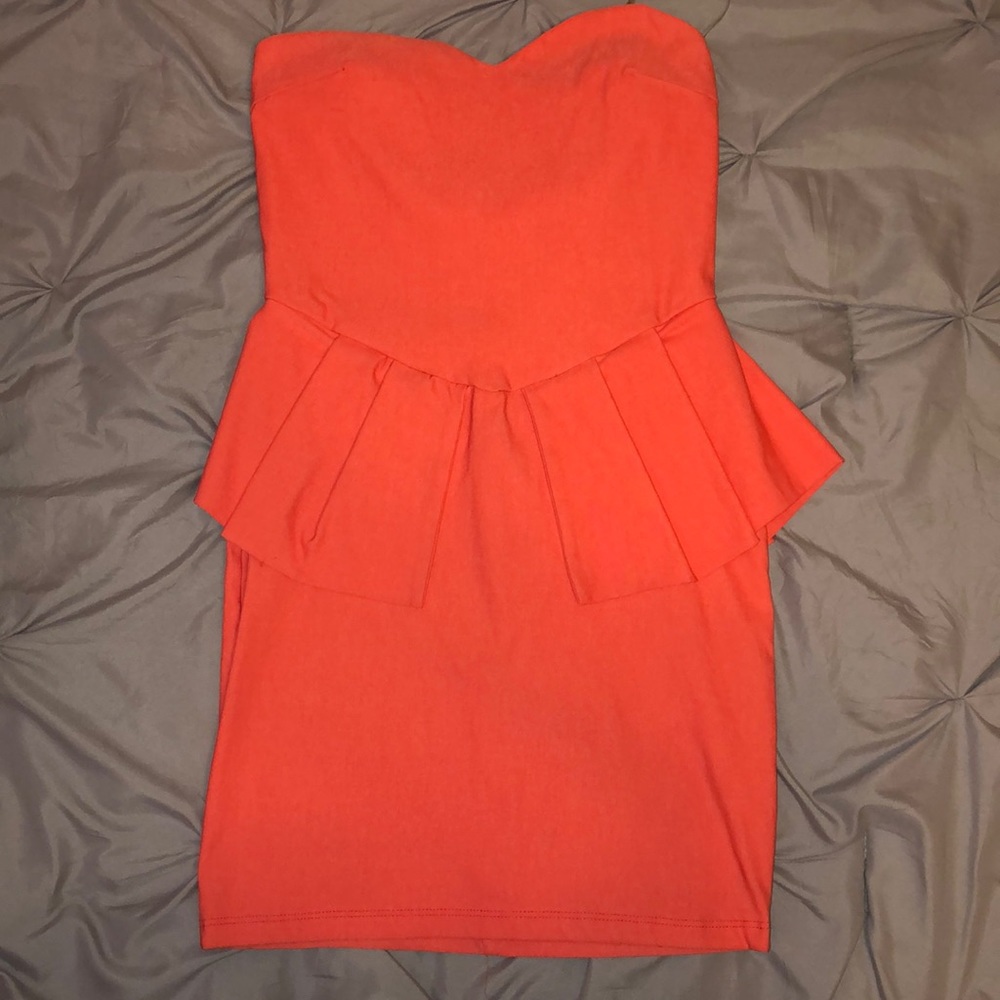 Coral mini peplum dress.